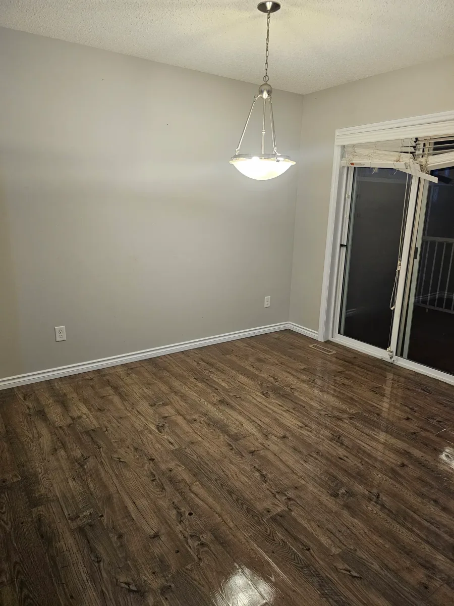 Post-construction cleaning result, spacious room with hardwood floors ready for occupancy