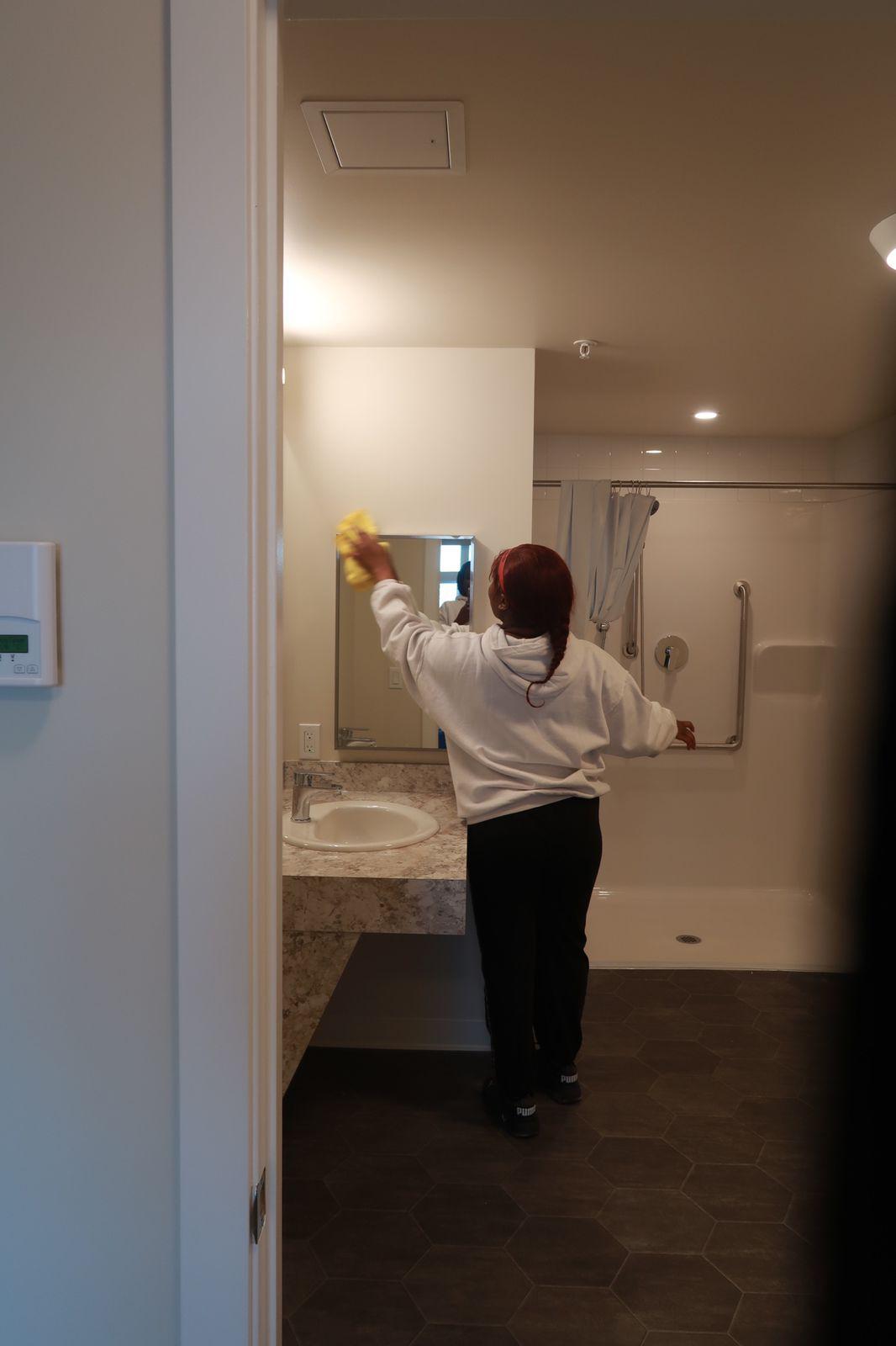 Cleaning a commercial bathroom mirror