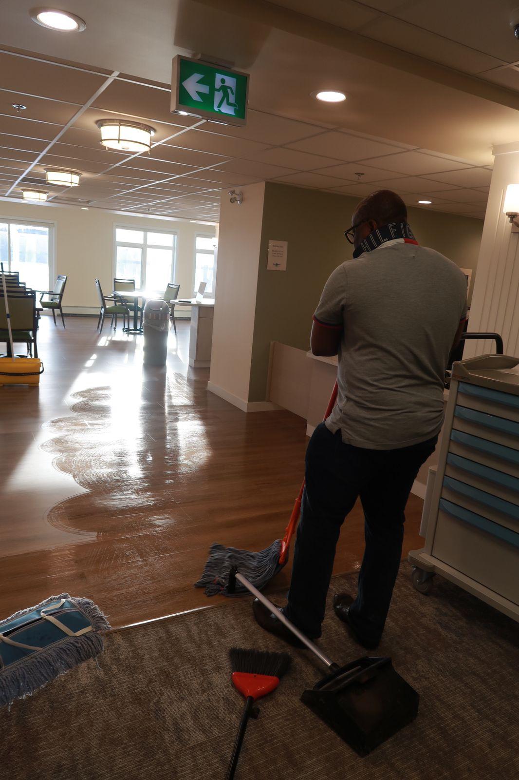 Kanians Pro Clean team member wet mopping a commercial hallway