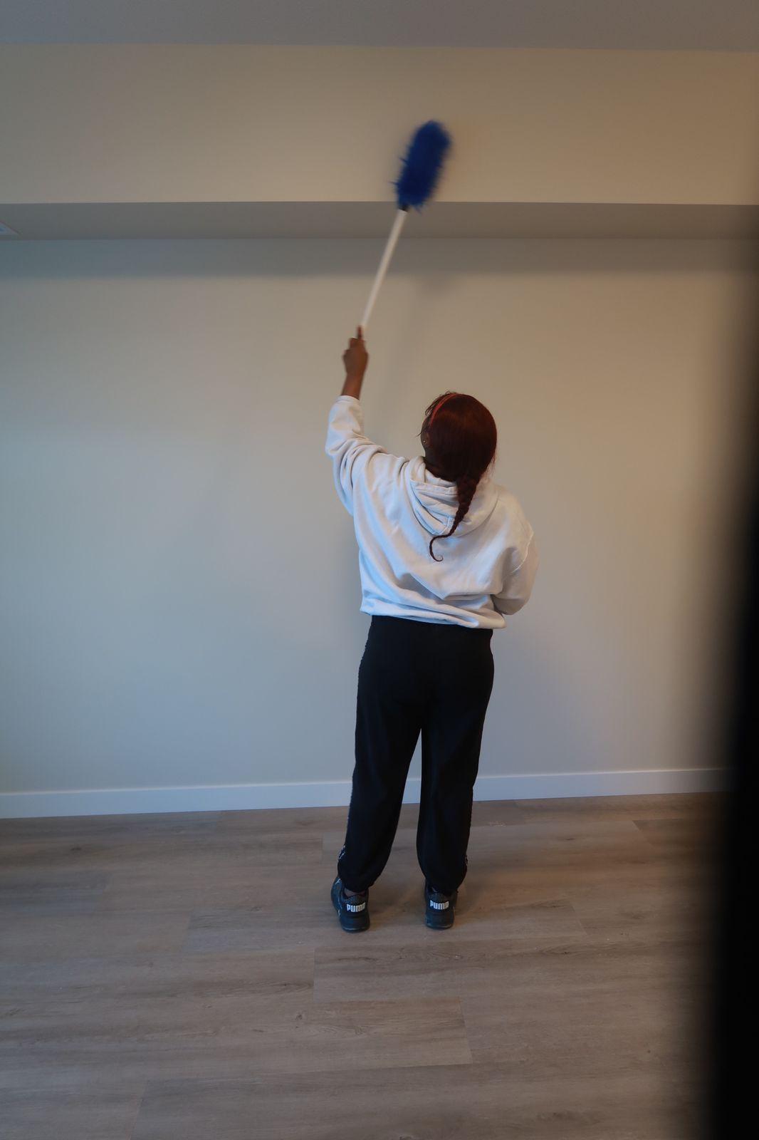 Kanians Pro Clean team member dusting walls in a freshly built space