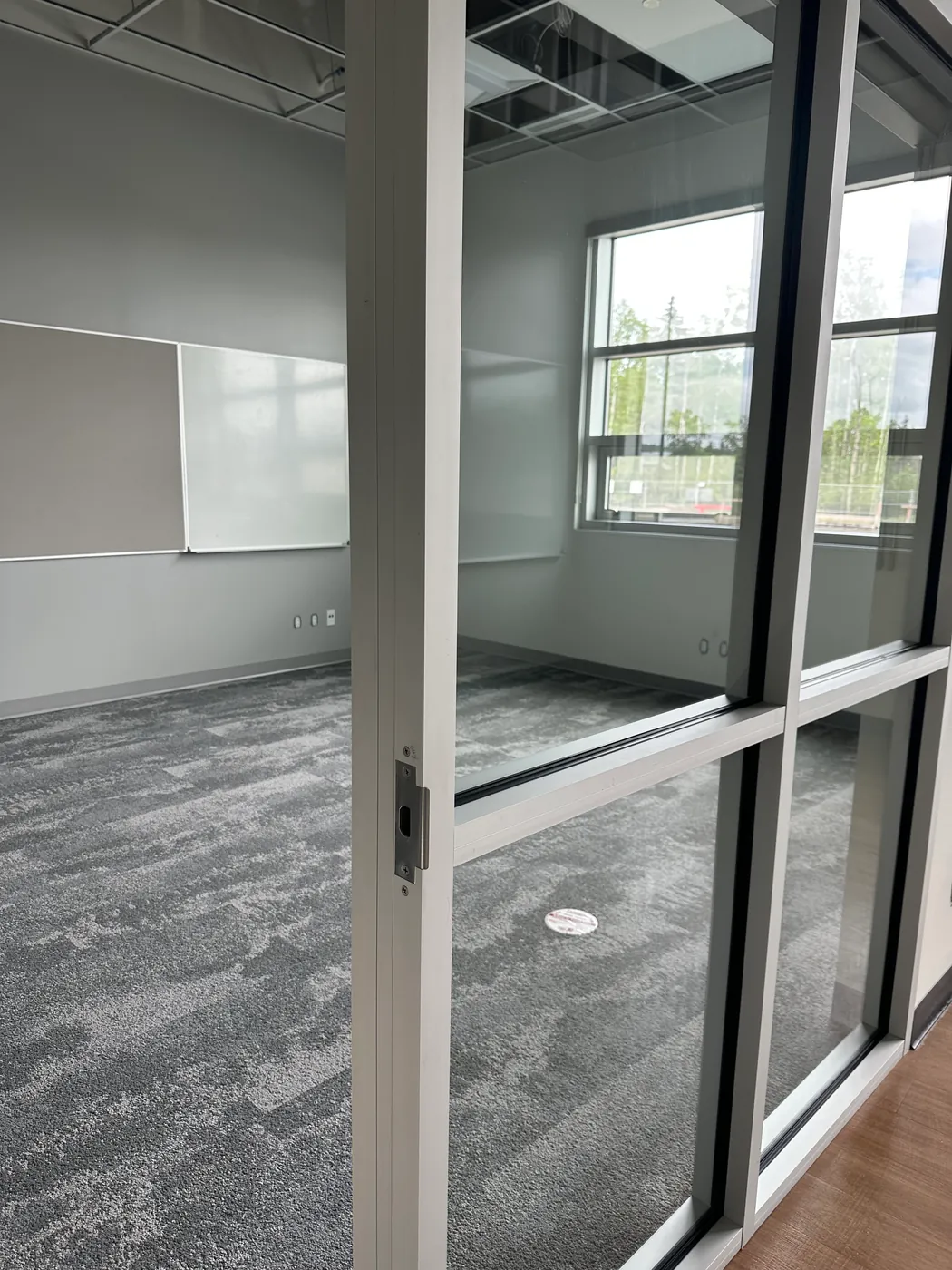 Spotless glass-walled office meeting room with fresh carpet, maintained by Kanians Pro Clean commercial cleaning